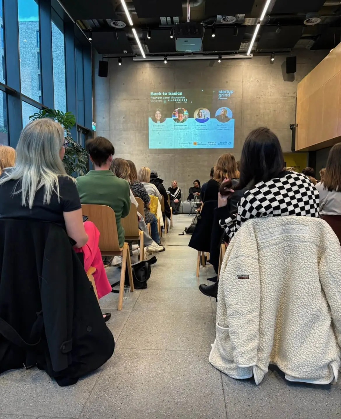 An audience watching a presentation slide