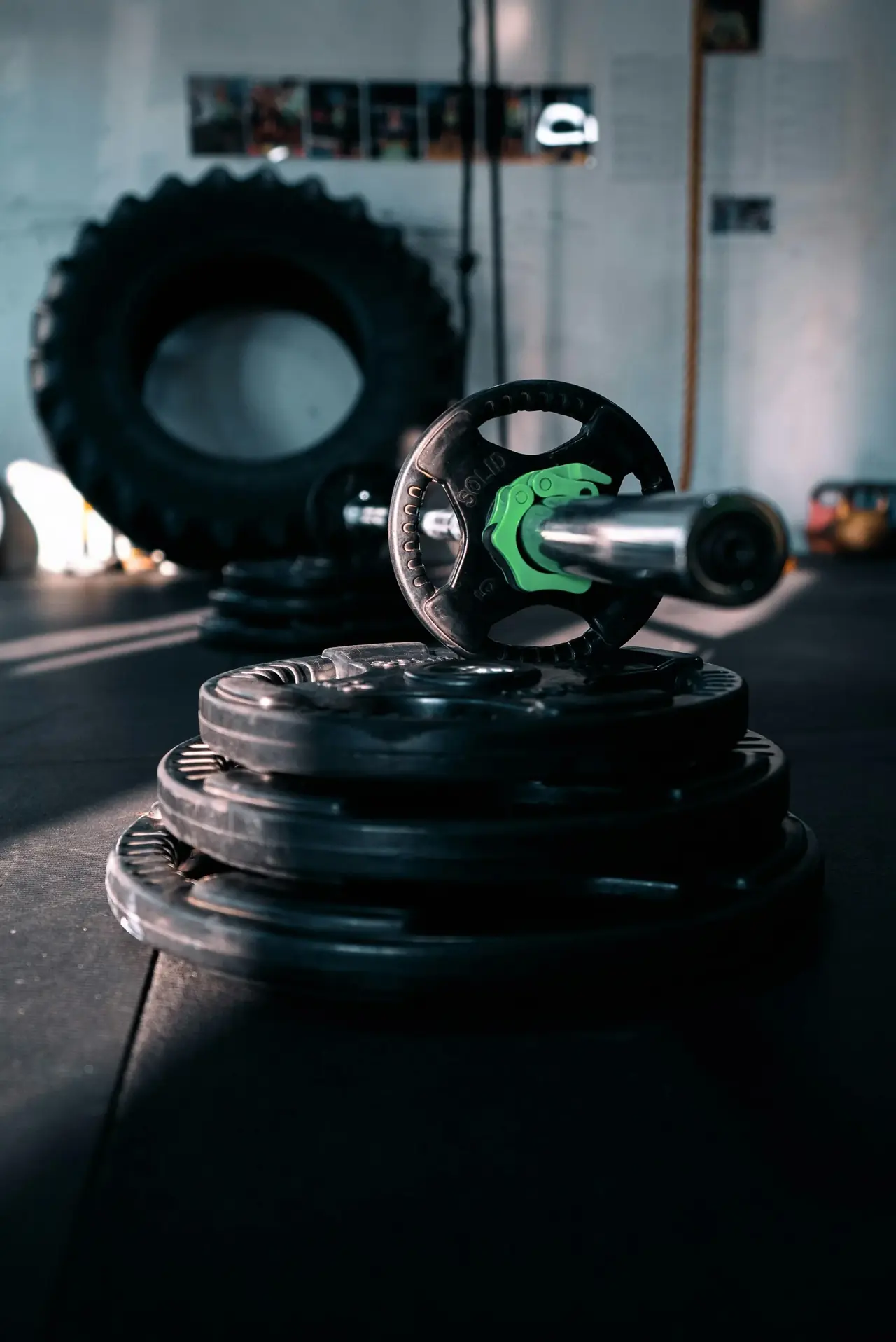 A barbell and weight plates on a gym floor