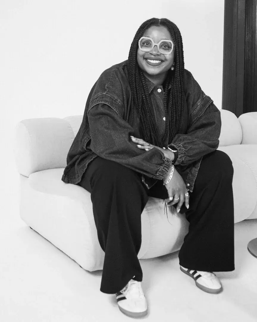 Vanessa Belleau seated, smiling, in black and white