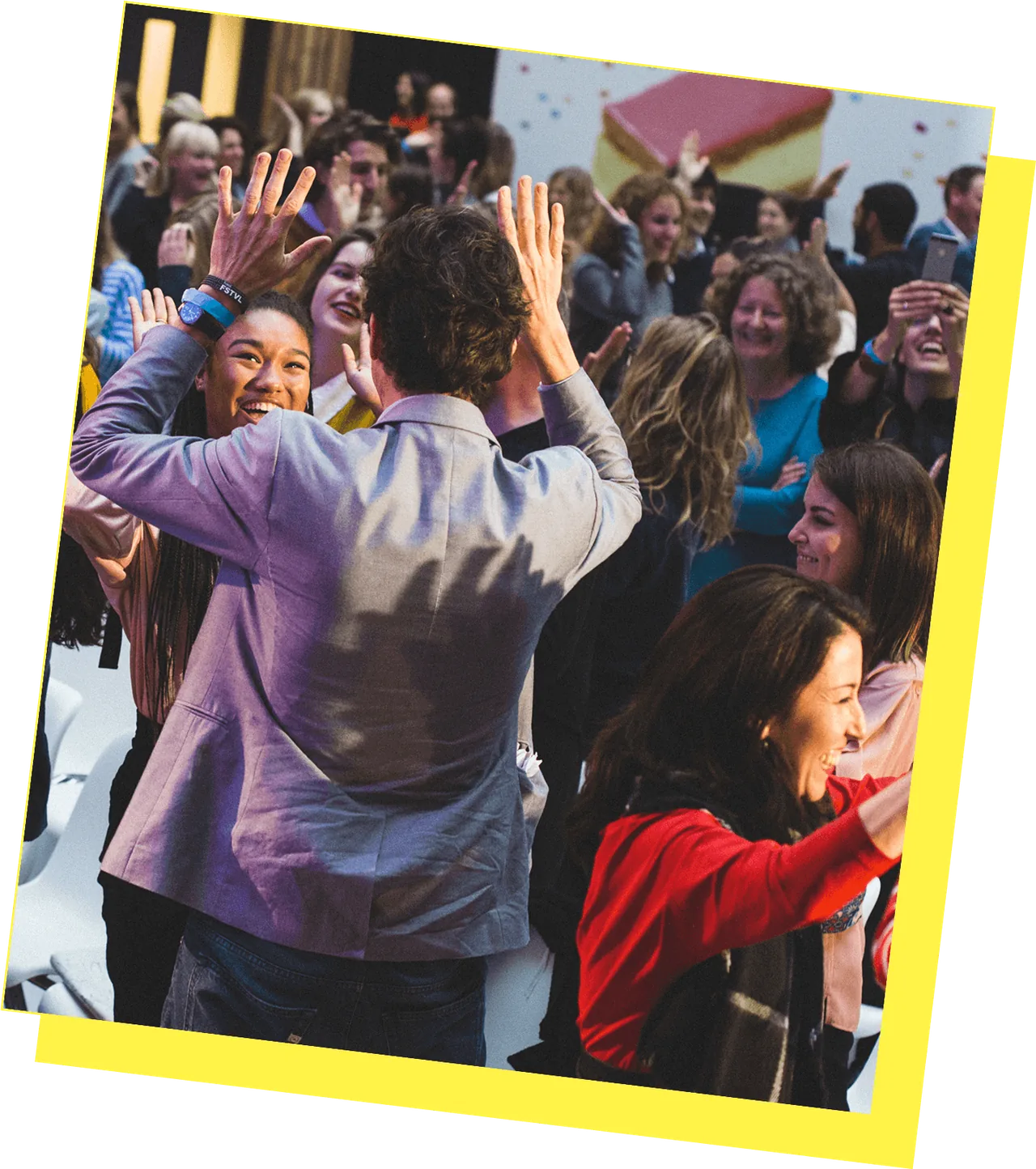 People celebrating and high-fiving at a crowded High Fifteen event