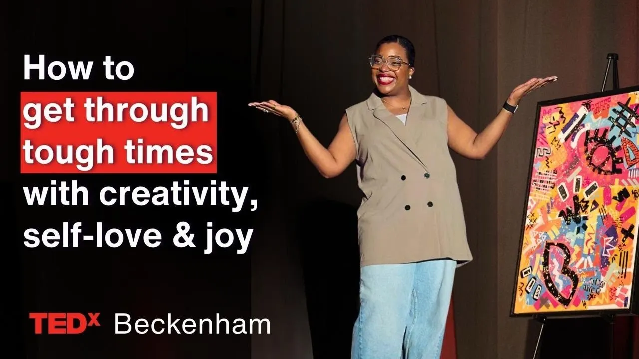 Vanessa Belleau on the TEDxBeckenham stage beside one of her paintings